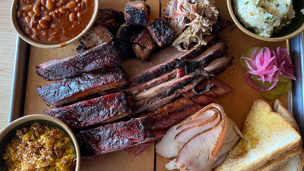 A barbecue platter with a variety of meats.