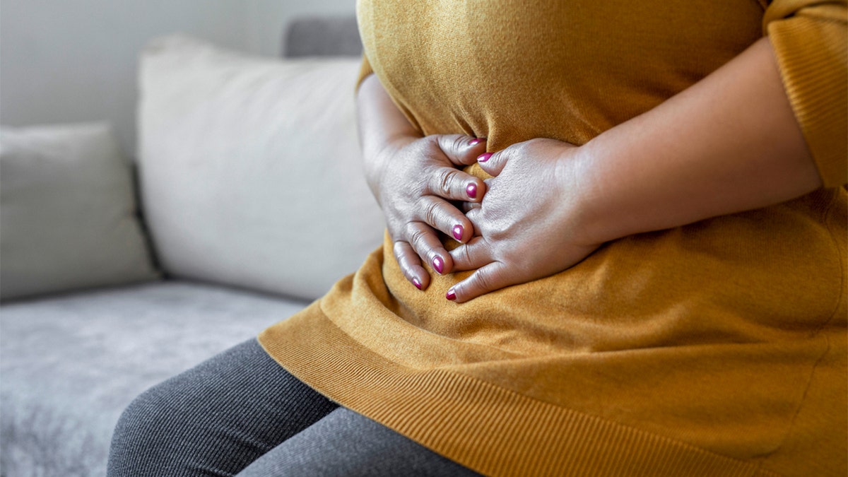 Woman clutching her stomach